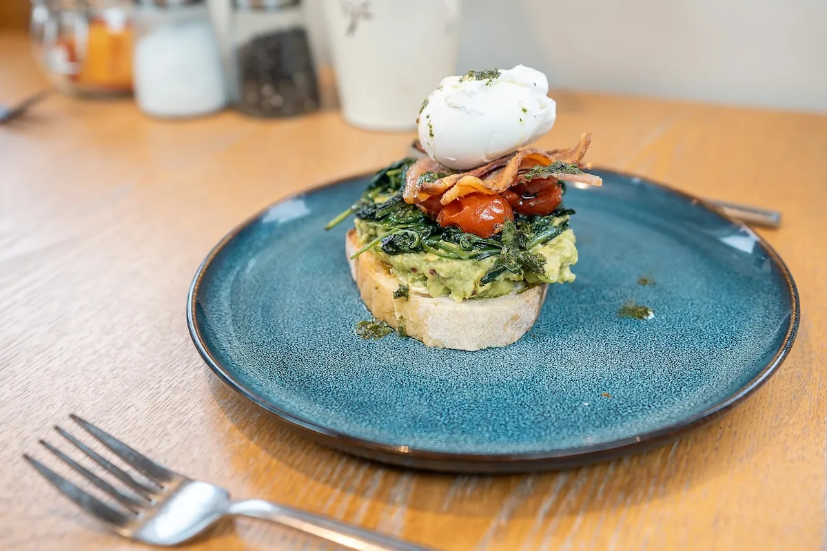 Close up of avocado tomato and poached egg on a piece of toast