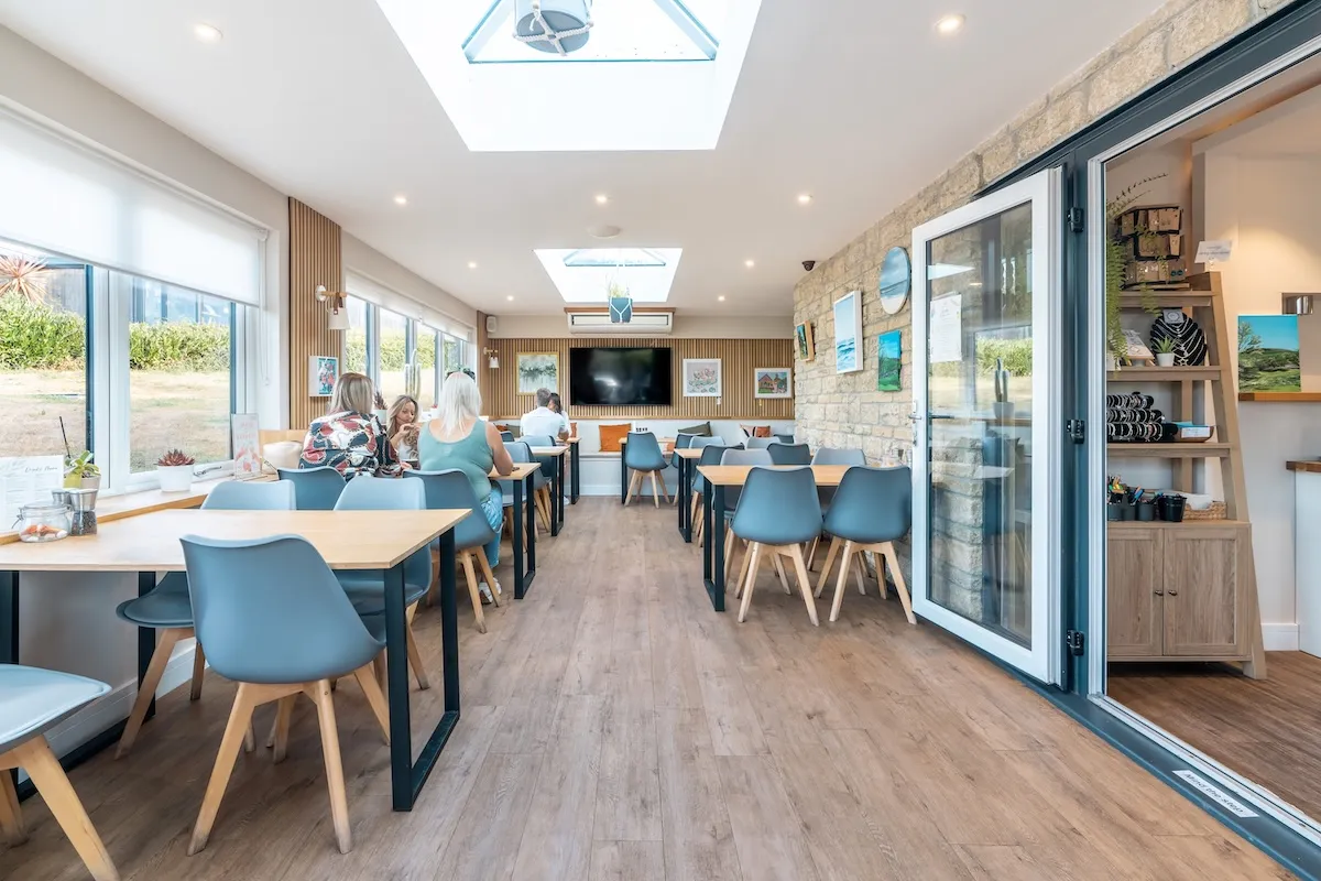 Inside view of restaurant with lots of natural light and tables