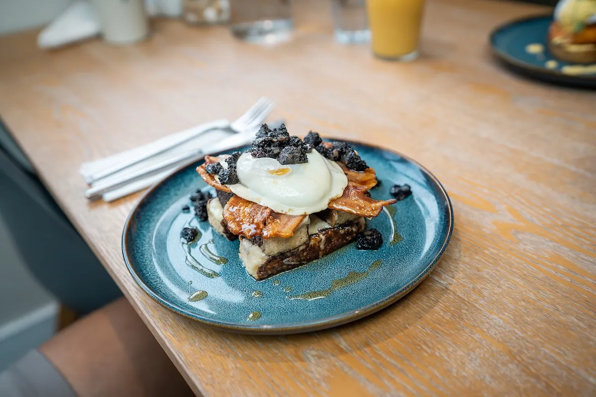Close up of pork belly with egg on toast on a plate